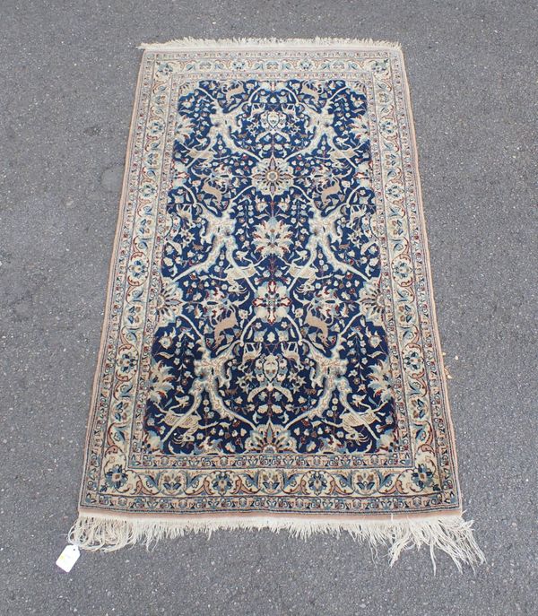 A FINELY KNOTTED SILK RUG