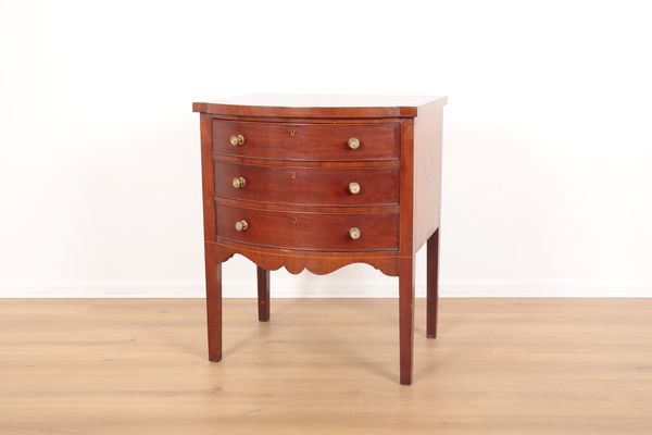 A MAHOGANY SERPENTINE CABINET IN GEORGE III STYLE