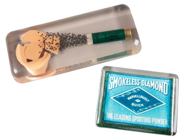 A '"SMOKELESS DIAMOND" THE LEADING SPORTING GUNPOWDER' PROMOTIONAL GLASS PAPERWEIGHT