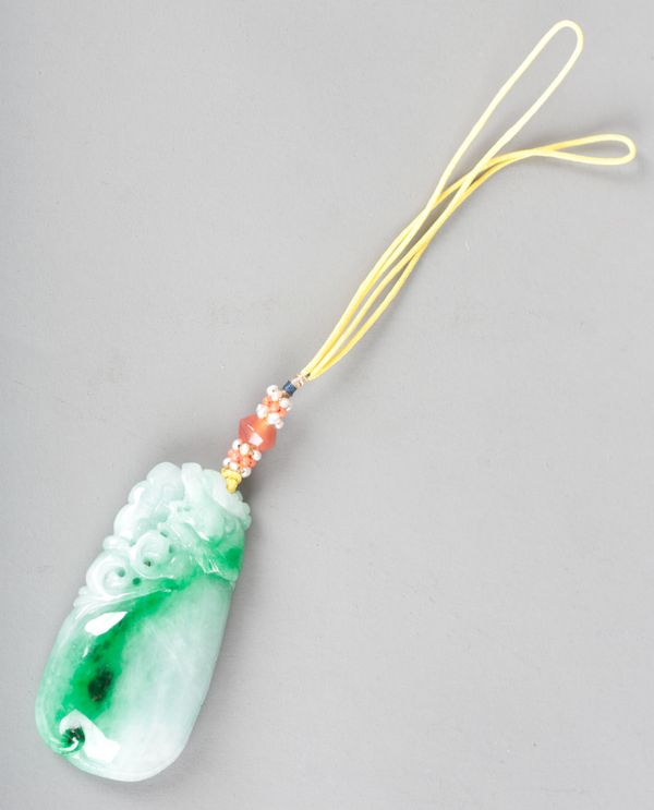 A CHINESE CARVED JADEITE PENDANT