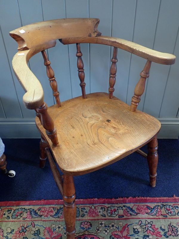 A 19th CENTURY SMOKERS BOW ARMCHAIR