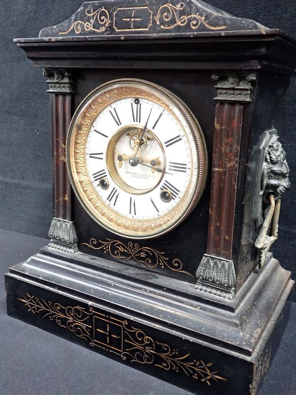 AN ANSONIA FAUX-SLATE  CASED MANTEL CLOCK