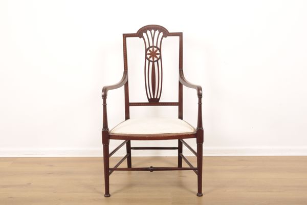 AN EDWARDIAN MAHOGANY NURSING CHAIR
