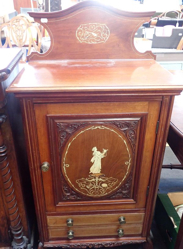 A LATE VICTORIAN CARVED AND INLAID MUSIC CABINET