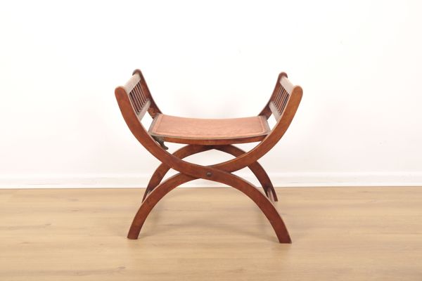 AN EDWARDIAN MAHOGANY 'X-FRAME' COLLAPSIBLE FOLDING STOOL