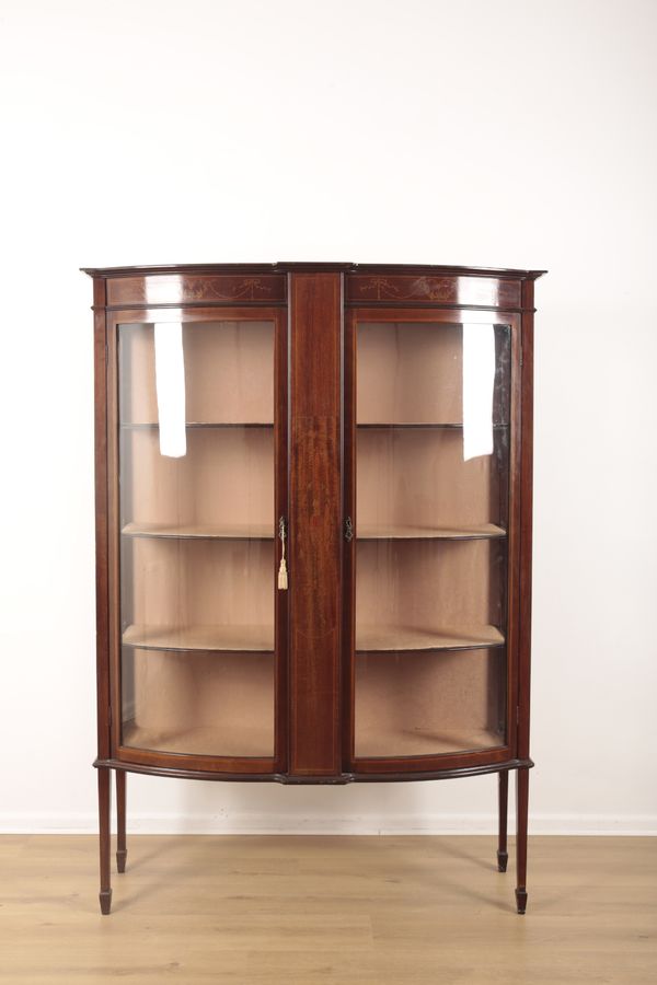 A MAHOGANY EDWARDIAN BOW FRONT GLAZED DISPLAY CABINET