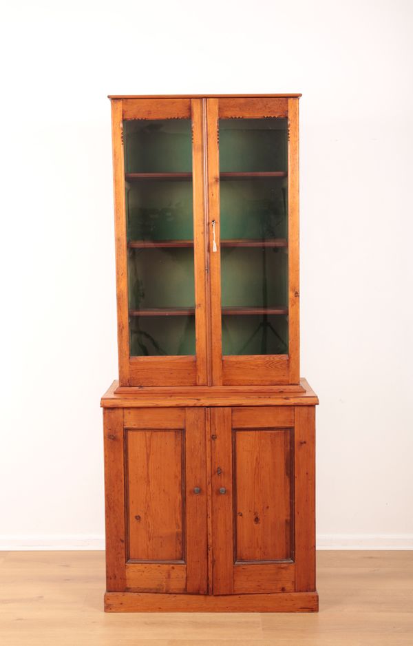 A PINE GLAZED BREAKFRONT CABINET