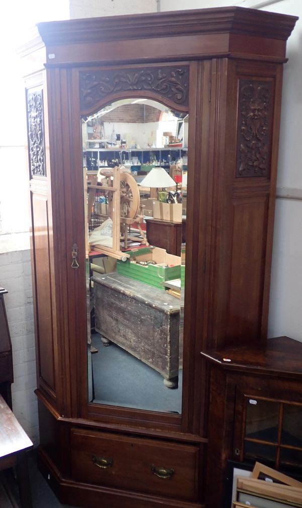 A LATE VICTORIAN CARVED WALNUT CORNER WARDROBE