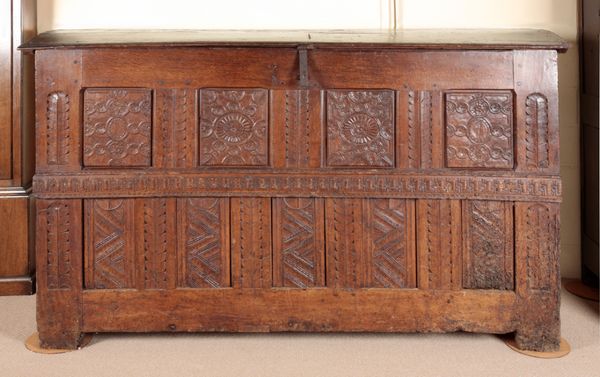 A CARVED AND PANELLED GRAIN COFFER