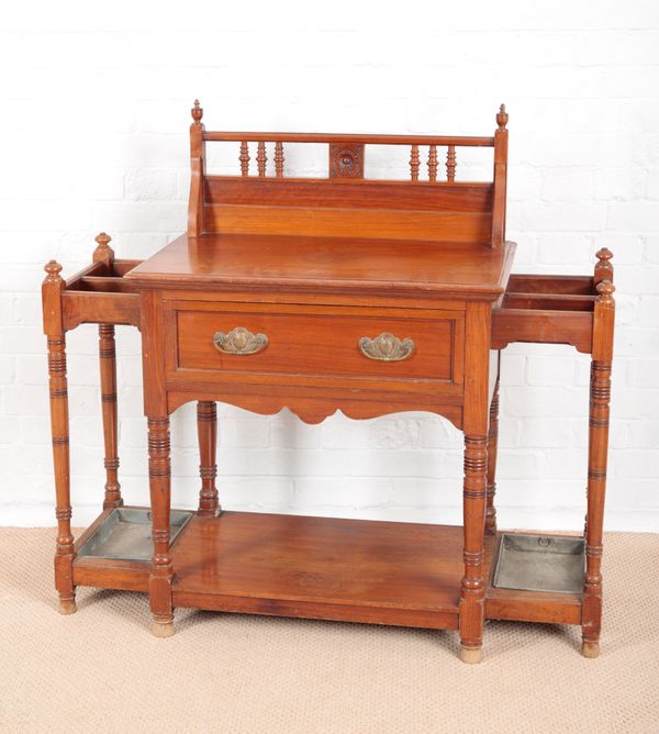 A LATE VICTORIAN WALNUT UMBRELLA STAND