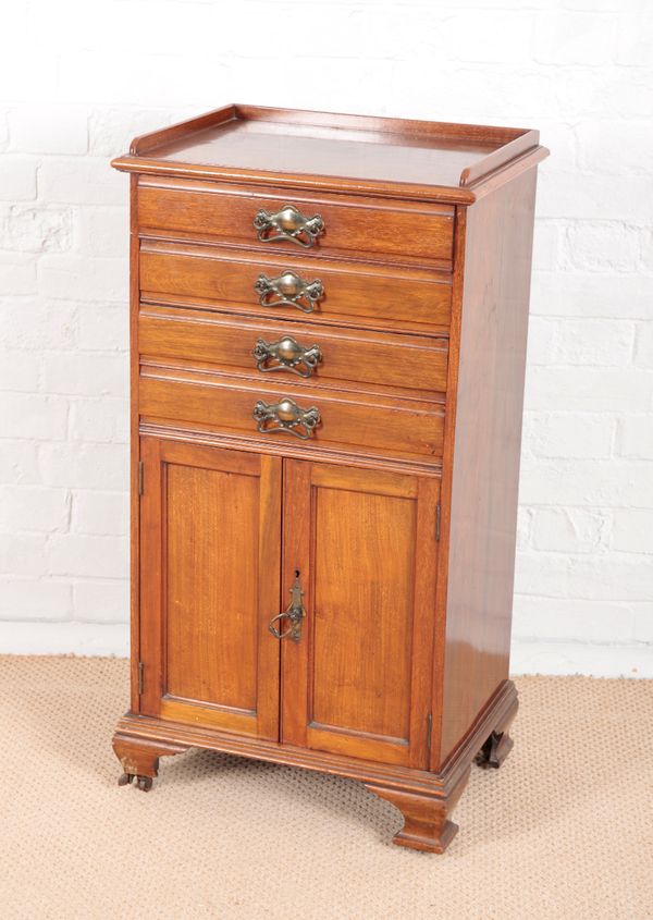 AN EDWARDIAN WALNUT MUSIC CABINET