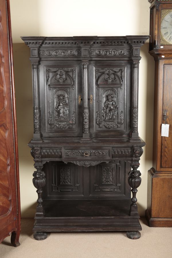 A VICTORIAN GOTHIC REVIVAL EBONISED CABINET ON STAND