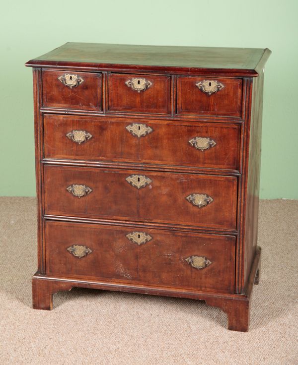 A WALNUT CHEST OF DRAWERS