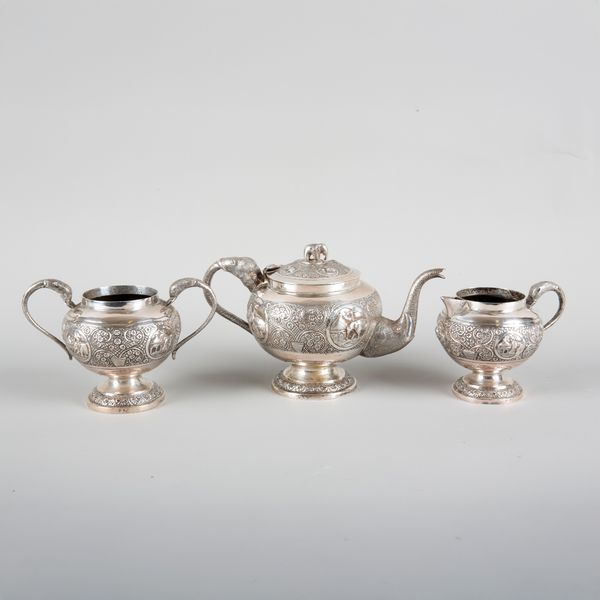 AN INDIAN THREE PIECE WHITE METAL TEA SERVICE