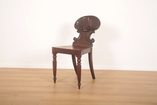 A MAHOGANY HALL CHAIR WITH SCALLOP SHELL BACK