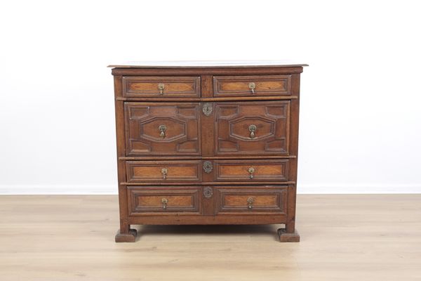 A WALNUT CHEST OF DRAWERS