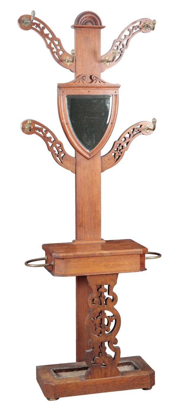 A VICTORIAN OAK HALL STAND WITH SHIELD SHAPED MIRROR