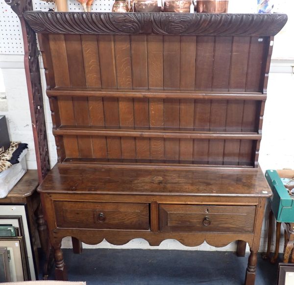 AN OAK DRESSER, THE BASE WITH TWO LARGE DRAWERS