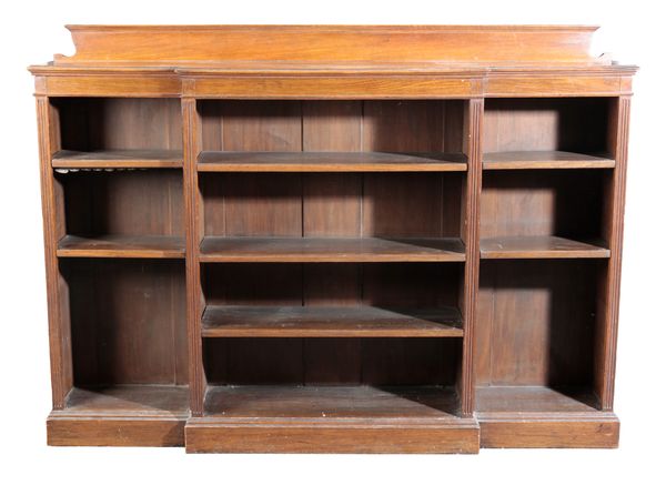 AN EDWARDIAN OAK BREAKFRONT OPEN BOOKCASE
