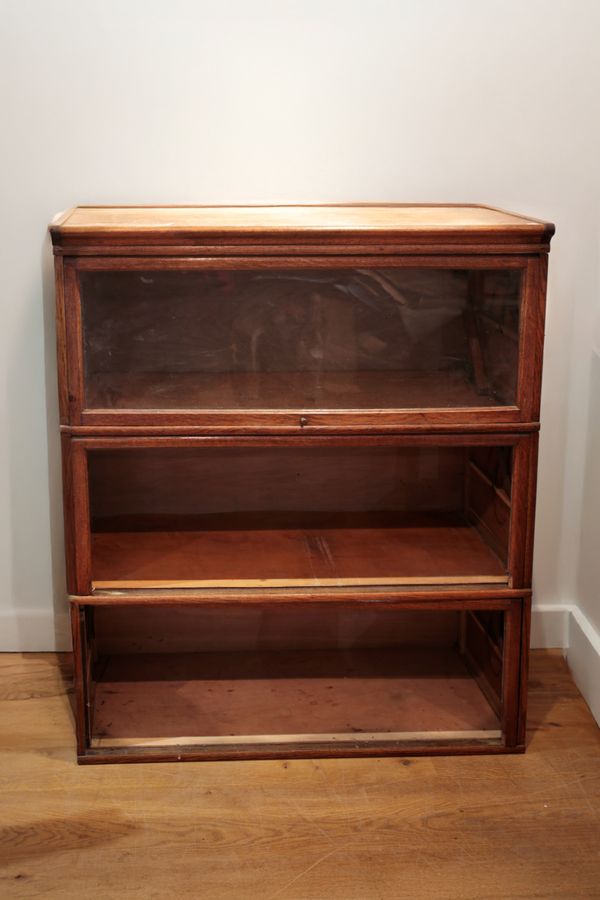 AN OAK GLOBE WERNICKE STYLE THREE TIER SECTIONAL BOOKCASE