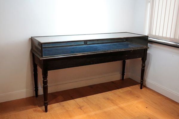 A VICTORIAN EBONISED WOOD ‘MUSEUM’ DISPLAY CASE ON STAND