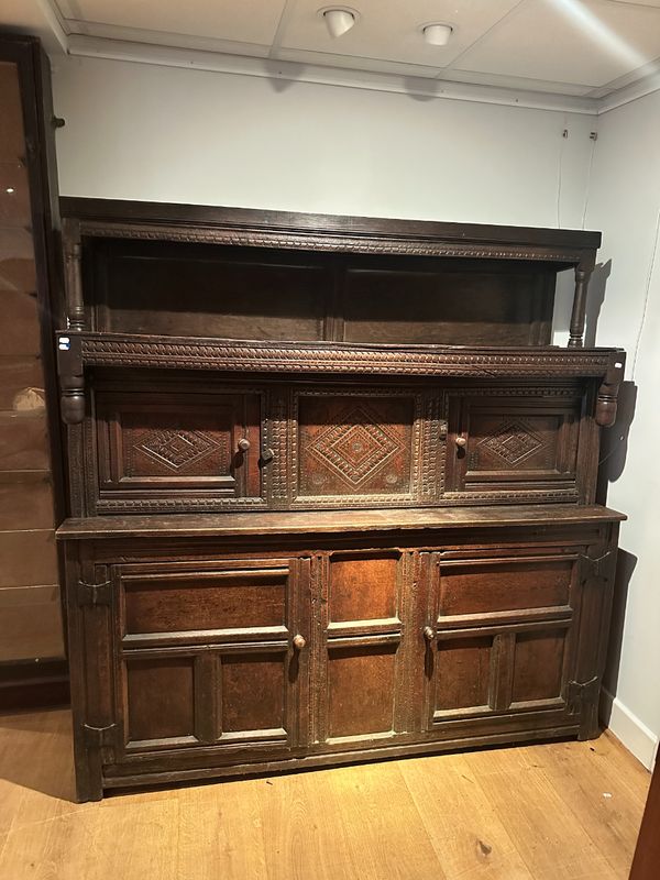 AN ENGLISH OAK COURT CUPBOARD