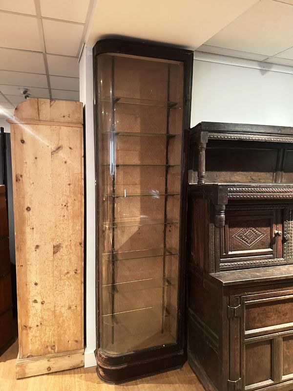 A VICTORIAN 'D-SHAPED' STAINED PINE AND GLAZED CORNER DISPLAY CABINET
