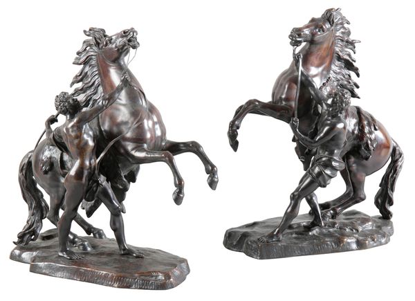 AFTER GUILLAUME I COUSTOU (1677-1746) A pair of bronze marly horses