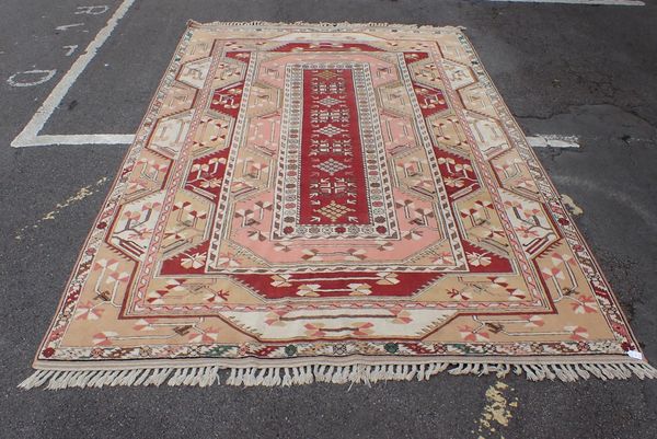 AN ANATOLIAN TURKISH CARPET, IN SOFT REDS, PINKS AND YELLOWS