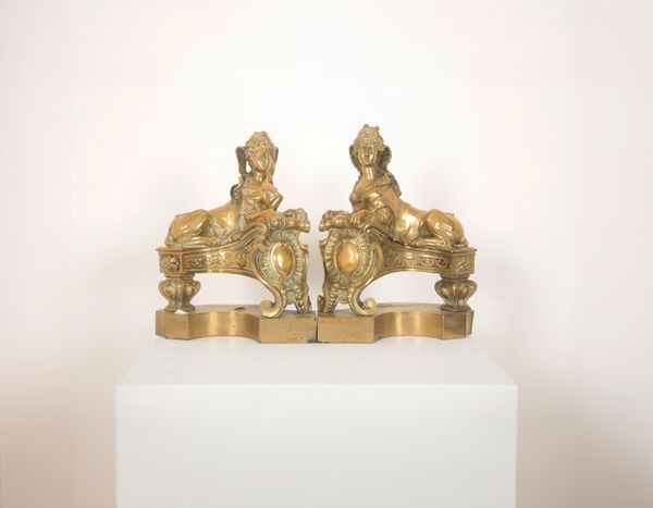 A PAIR OF SPHINX BRASS ANDIRONS OR FIRE DOGS POSSIBLY AFTER NICOLAS COUSTOU