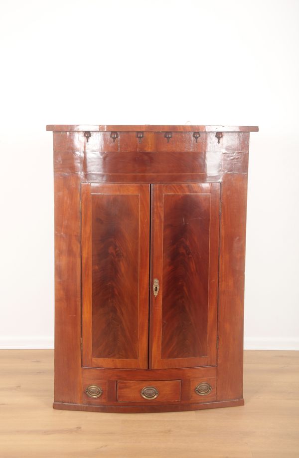 A GEORGE III FLAME MAHOGANY BOW FRONT WALL CABINET