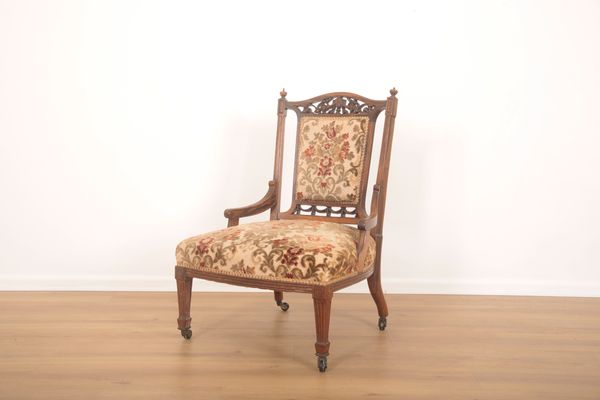 A VICTORIAN ROSEWOOD NURSING OR OCCASIONAL LOW ARMCHAIR