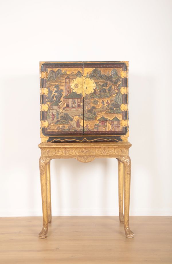 A BLACK LACQUER AND CHINOISERIE DECORATED CABINET ON STAND