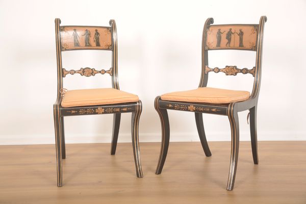 A PAIR OF EBONISED AND PARCEL-GILT CHAIRS IN REGENCY STYLE