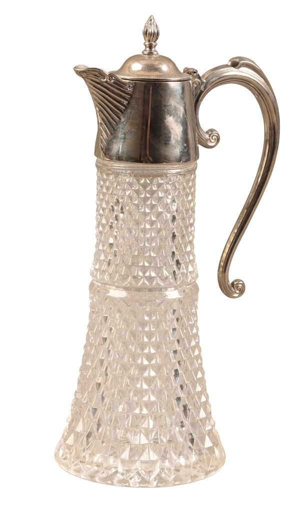 A SILVER PLATED GLASS CLARET JUG