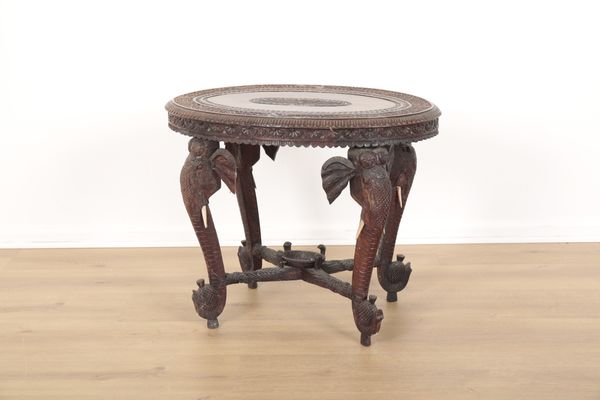 AN INDONESIAN OR INDIAN CARVED HARDWOOD OVAL OCCASIONAL TABLE