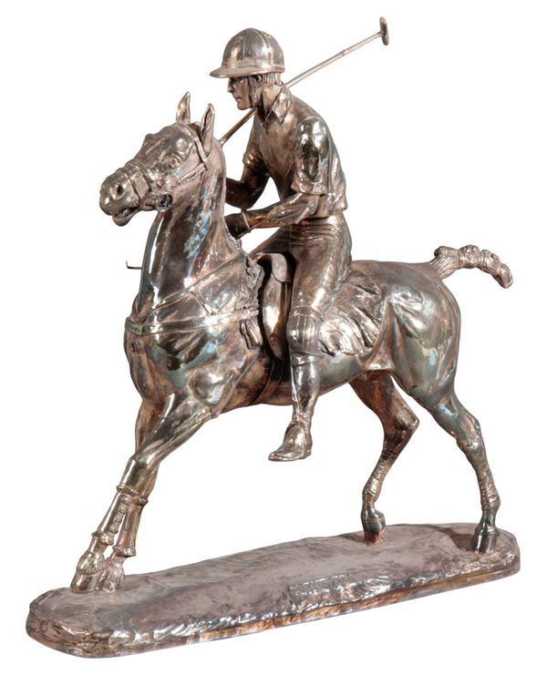 A SILVER FIGURE OF POLO PLAYER ON HORSE BACK