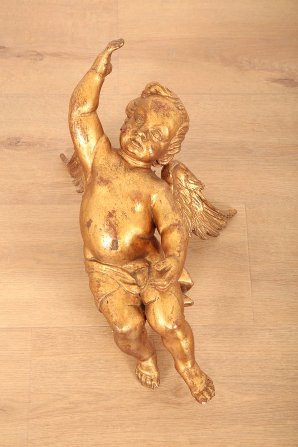 A GILDED AND CARVED WOOD PUTTO