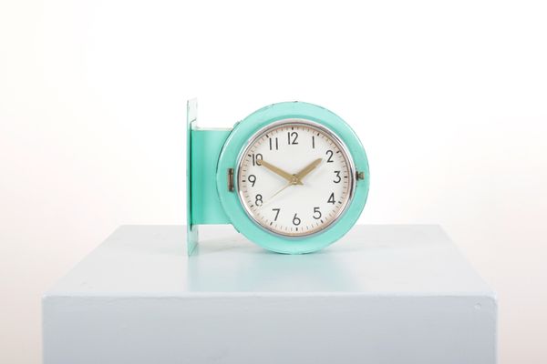 A DOUBLE-DIAL ROUND METAL SHIP'S CLOCK