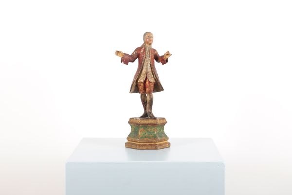 A POLYCHROME PAINTED FIGURAL WOOD CARVING