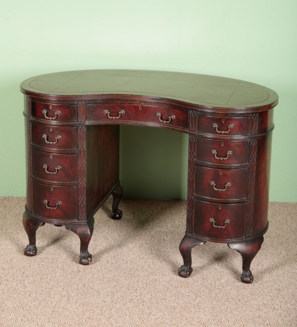 AN EDWARDIAN MAHOGANY KIDNEY-SHAPED DESK