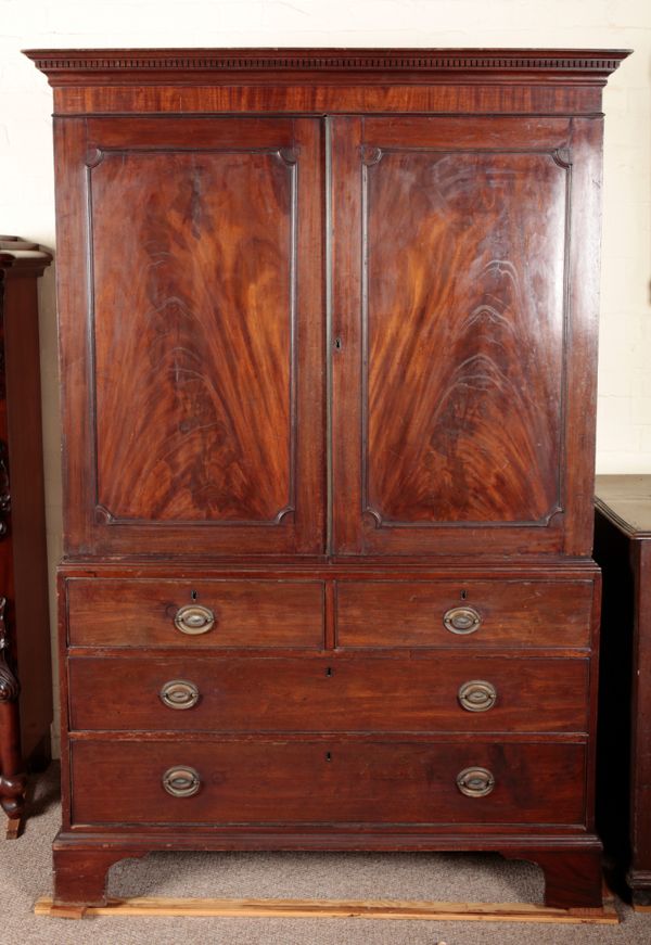 A GEORGE III FLAME MAHOGANY LINEN PRESS