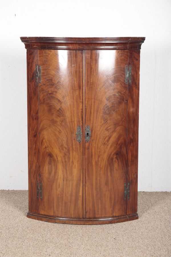 A GEORGE II FLAME MAHOGANY HANGING CORNER CABINET