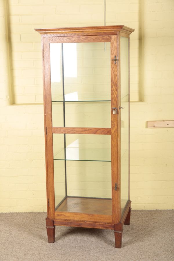 AN EDWARDIAN OAK SHOP DISPLAY CABINET