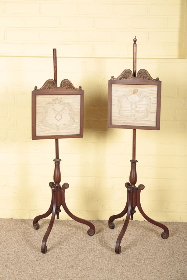 A PAIR OF REGENCY MAHOGANY AND GILT METAL MOUNTED POLE SCREENS