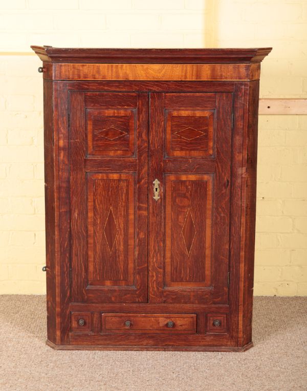 A GEORGE III OAK AND CROSSBANDED CORNER CUPBOARD