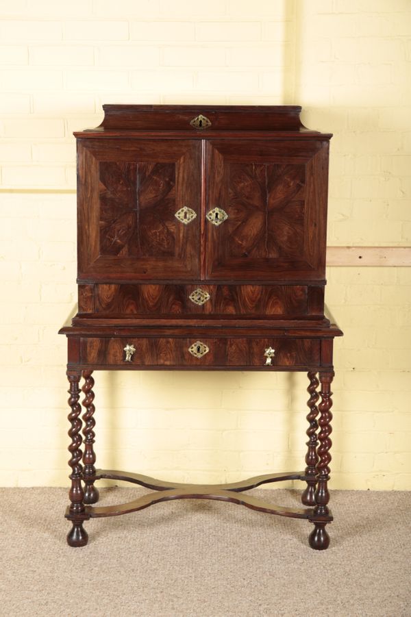 A WILLIAM AND MARY OYSTER VENEERED CABINET ON STAND