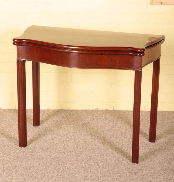 A GEORGE III MAHOGANY SERPENTINE CARD TABLE