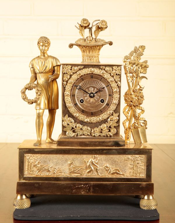 A FRENCH GILT METAL MANTEL CLOCK