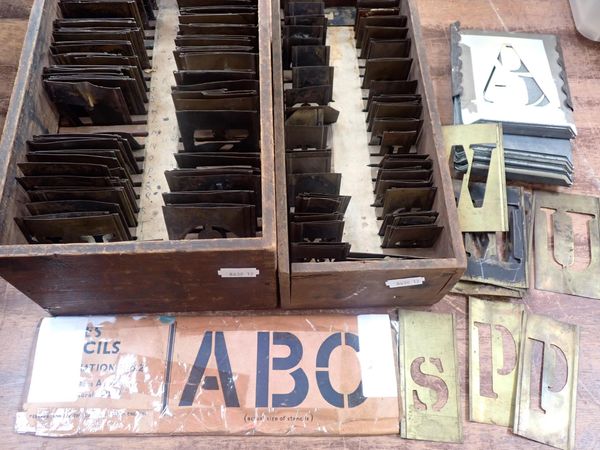 A SET OF BRASS LETTERING STENCILS